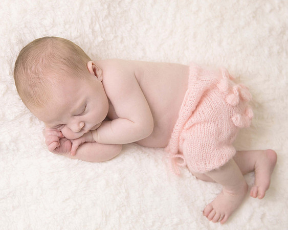 Baby girl on beanbag in peach
