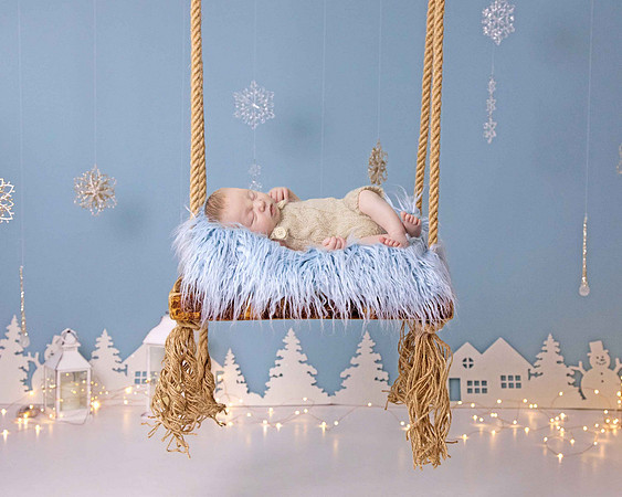 Newborn baby boy on swing Christmas