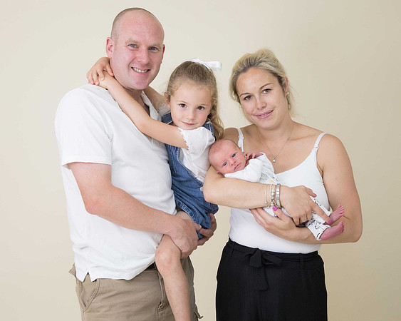 Family posing with newborn