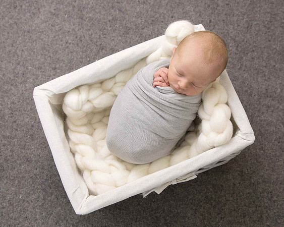 Baby boy in grey in basket