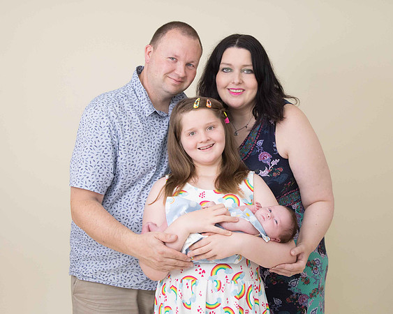 Family posing with newborn