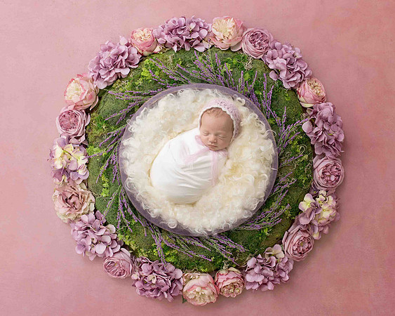 Newborn baby girl in composite background
